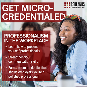 Woman in blue shirt smiling, while demonstrating professional workplace behavior she learned from her micro-credential