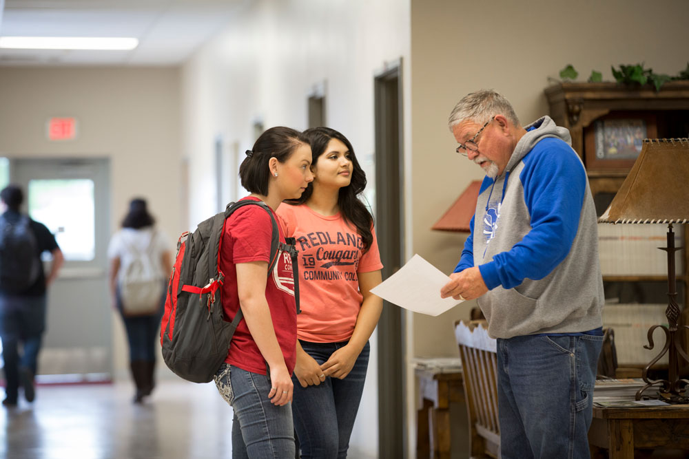 students talking to teacher