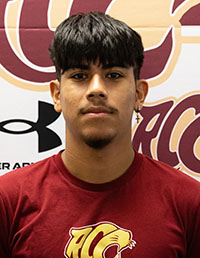 Smiling male student with dark hair and a goatee