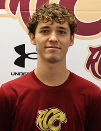 Smiling male student with curly hair