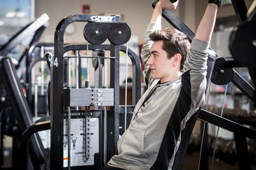 student lifting weights