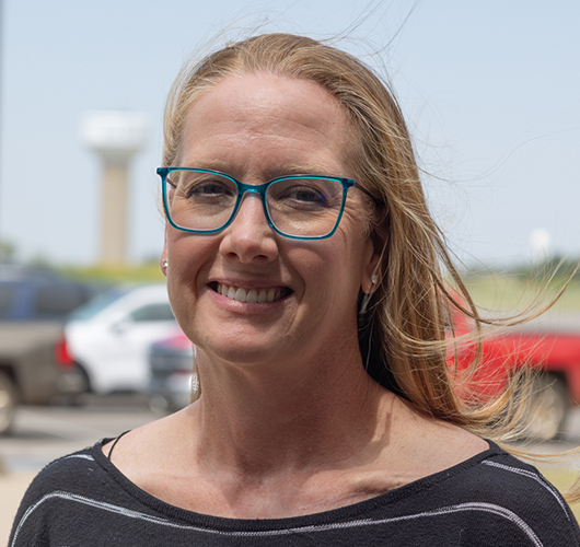 Woman with blonde hair and blue glasses