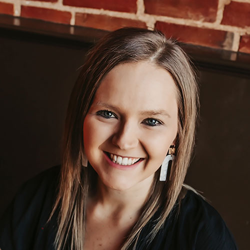 Woman with long brown hair and black shirt