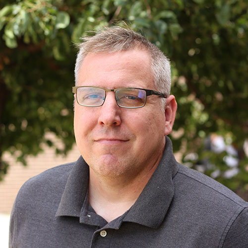 Man with light hair and glasses