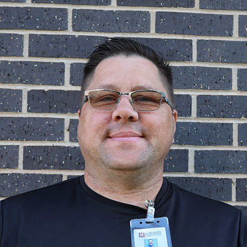 Man with dark hair and glasses