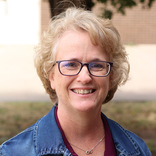 Woman with light brown hair and glasses