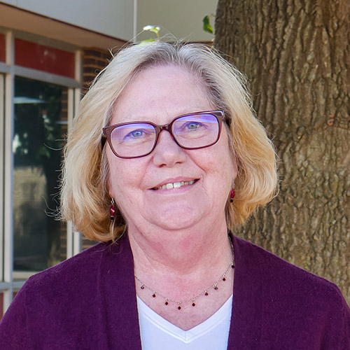 woman with blonde hair and glasses