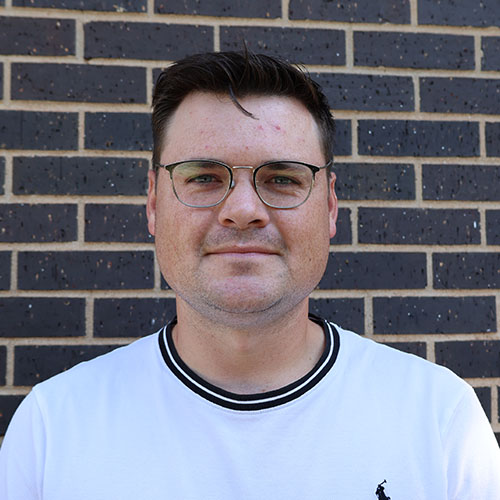 Man with short dark hair and glasses