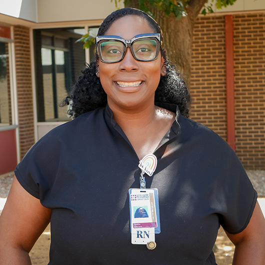 Woman with black hair and glasses