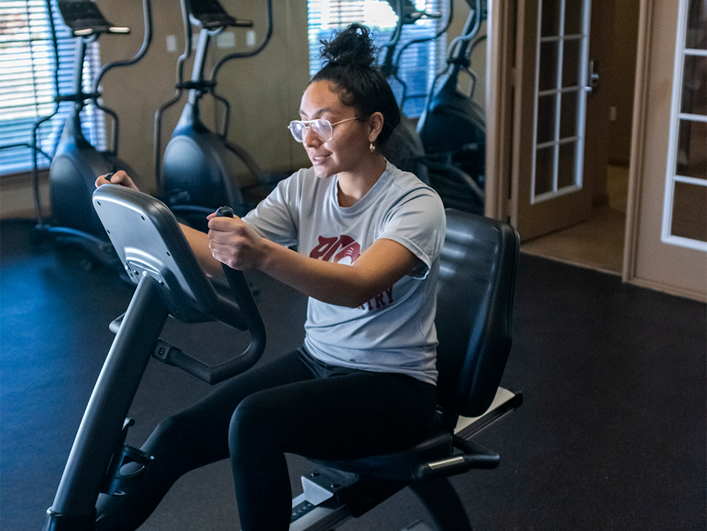 Woman rides a stationary bike in the fitness center