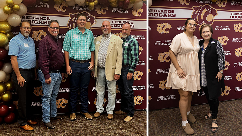 Multiple people stand in front of a maroon and gold backdrop