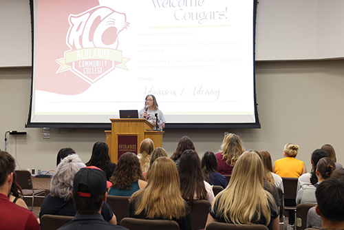 President Jena Marr speaks to a room full of people