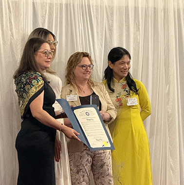 Women present an award to Professor Cherry Rain