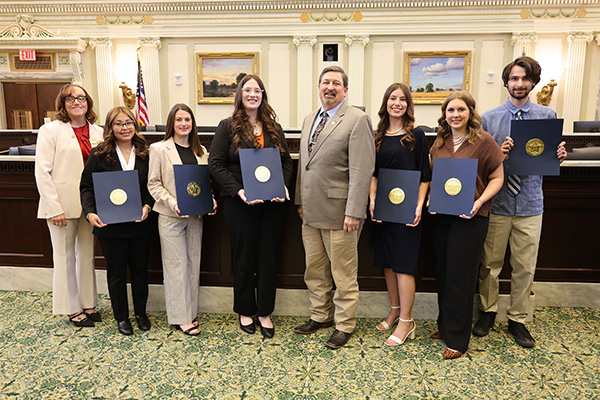Group of students with president and state representative receiving certificates