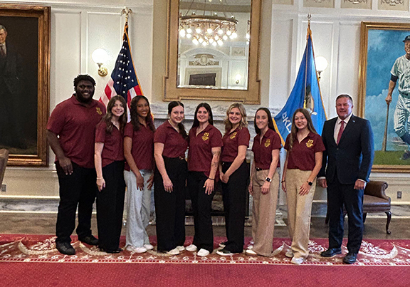 Group of students in the state capitol with a legislator