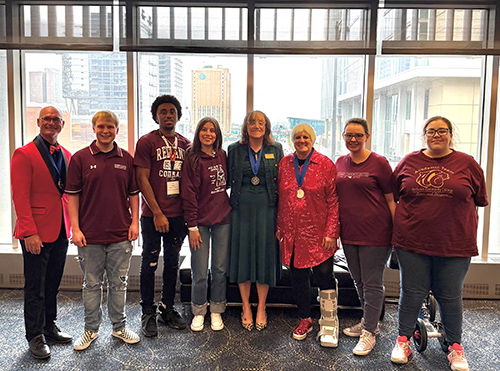 PTK advisors and President Marr are standing with five students who are wearing Redlands shirts.
