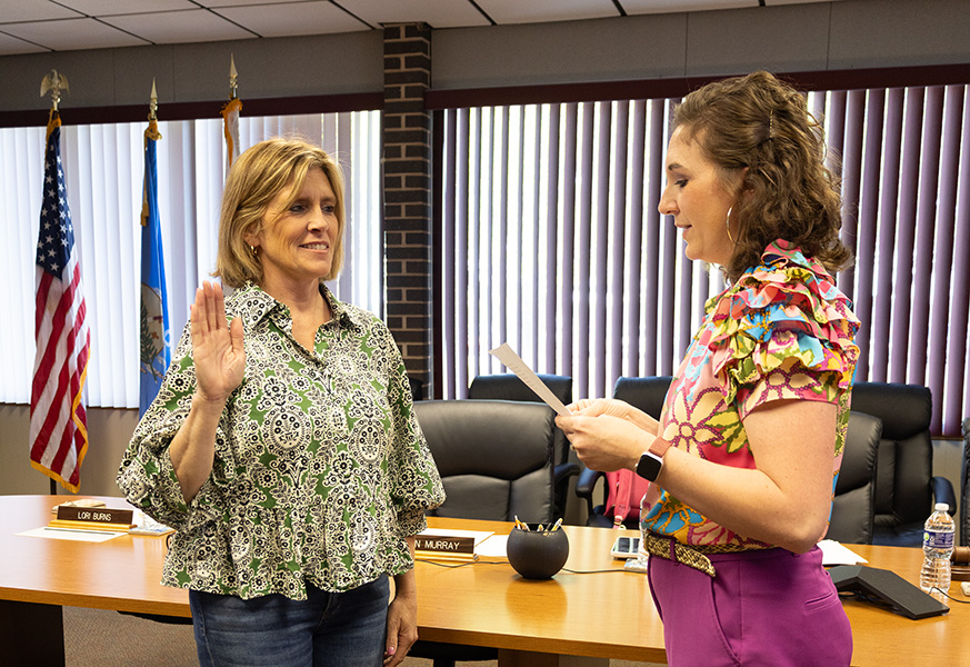 One woman administers the oath of office to another woman