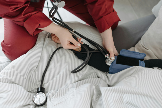 Overhead view of nurse taking vitals on a patient's arm