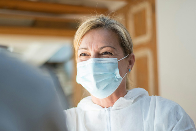 Smiling nurse in white mask