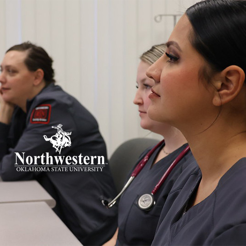 Three nursing students in navy scrubs