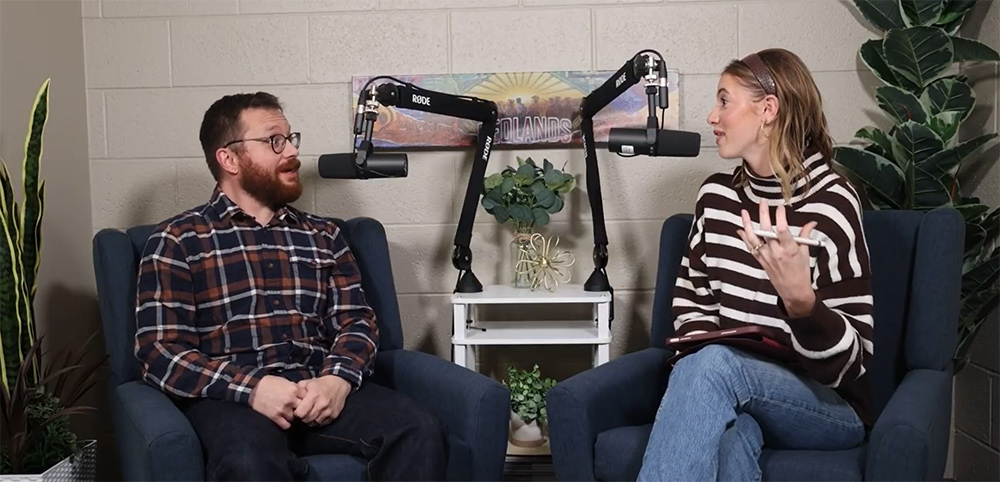Woman in a stiped sweater sits next to a man in a dark flannel shirt