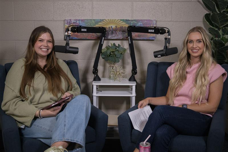 Woman in green shirt next to woman in pink shirt