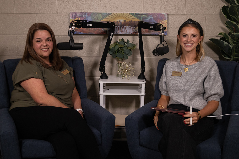 Woman in green shirt next to woman in grey shirt
