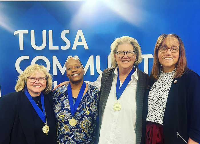 President Jena Marr congratulates OACC award recipients Marcia Shottenkirk, Stephanie Fisher and Debbie Newberry. 