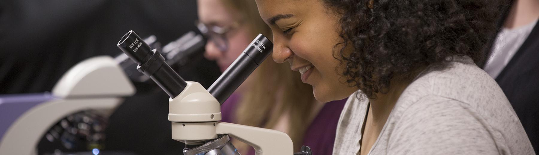Students use microscopes